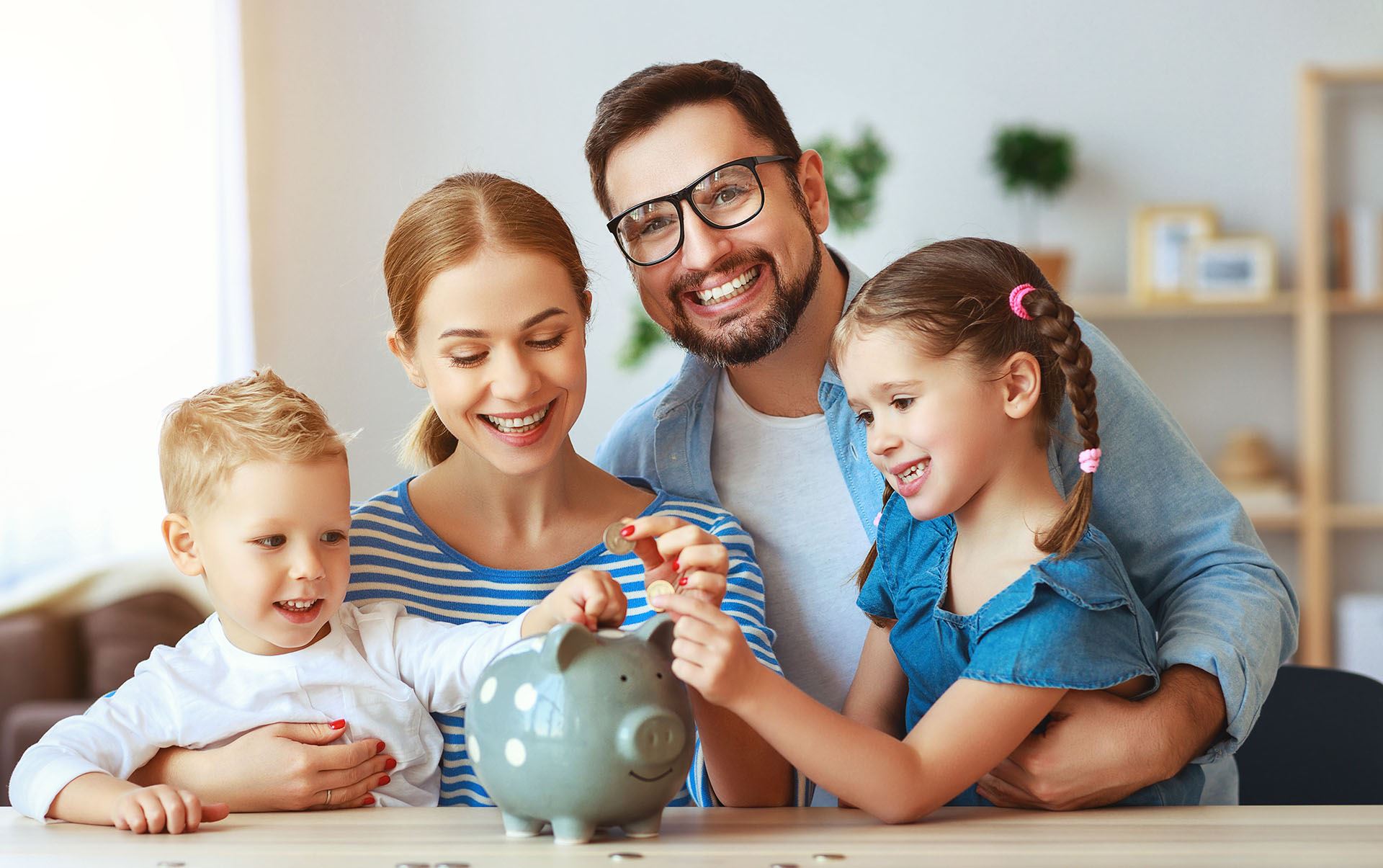 Family putting coins into a piggy bank